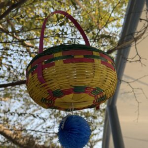 Colorful Hanging Woven Basket with Pom-Pom Detail